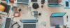 A bunch of laptops on a table from above